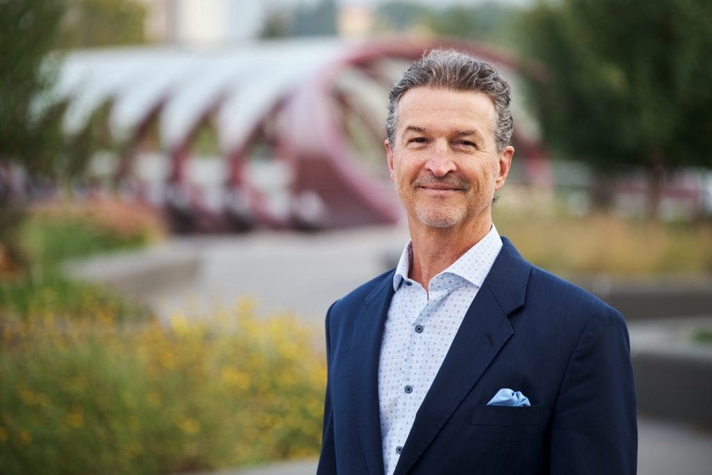 Calgary executive headshot of a confident middle-aged man in business attire.