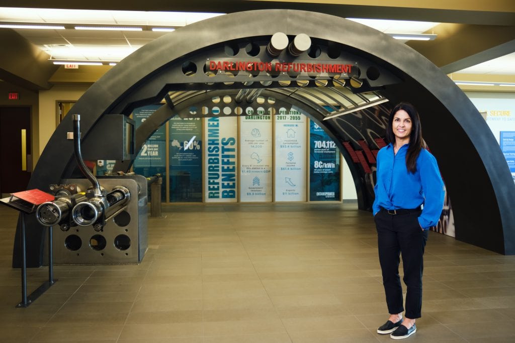 Woman standing at Calgary refurbishment center entrance.